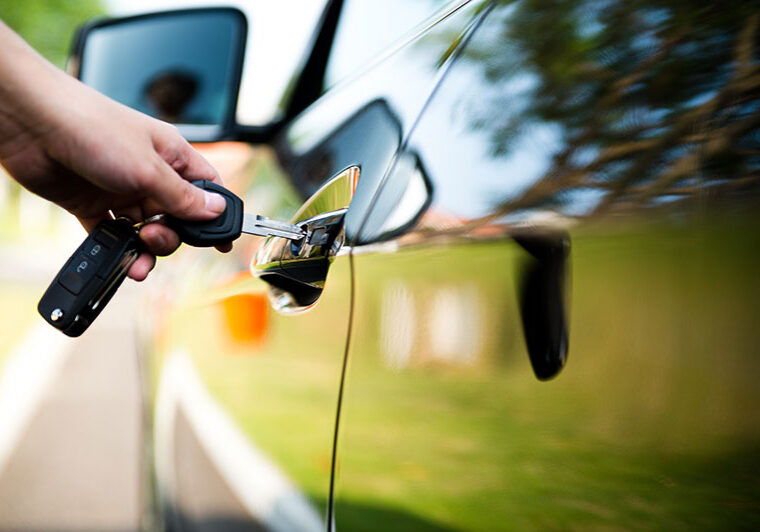 Car keys opening a car door